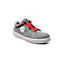 Grey safety shoe with red laces and a white label with text.