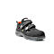 Black safety half shoe with Velcro fasteners. Side view, on a white background.
