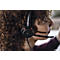 Close-up of a headset with a microphone on a person's head. The device is black, the microphone has a curved shape.