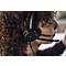 A person with curly hair wearing a black headset. The headset has the inscription "EPOS". Red lights are lit on the earpiece.