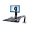 Desk set with monitor, keyboard, mouse and calculator. The monitor is held by an adjustable arm.