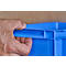 Close-up of a hand holding a blue plastic box by the handle.