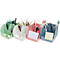 Quatre porte-stylos colorés avec des fournitures de bureau telles que des stylos, des ciseaux et des blocs-notes.