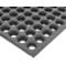 Close-up of a black rubber floor mat with hexagonal holes.