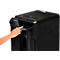 A hand presses the power button of a black shredder.