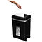 A hand inserting a white sheet of paper into a black paper shredder. Shredded paper is visible below.