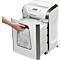 Person opening paper shredder drawer. The container is full of shredded paper. The device says "Fellowes".