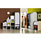 Man in office at cabinet wall, shelves to the left. Brick wall, clock, green wall.