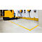 Yellow forklift in a warehouse, marked by yellow lines on the floor.