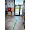 Green line leading to a door. On the wall: fire extinguisher, emergency exit sign, emergency plans.