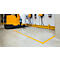 Yellow forklift in warehouse, yellow lines mark floor. Power boxes on wall.