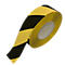Rolled black and yellow hazard tape roll, diagonal stripes. The background is white.