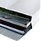 Close-up of a book with different layers of paper inserted in a white cover.
