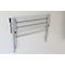 A gray, folded wall-mounted table with silver legs against a white wall.