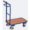 Blue transport trolley with brown loading surface and black handle, stands on a gray surface.