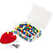 A transparent plastic box with colorful push pins; next to it a red cushion with push pins.