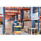 Forklift in warehouse, blurred. Shelves with pallets and boxes. Sign with information.