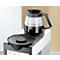Glass coffee pot with freshly brewed coffee on a coffee machine. Black jug with handle.