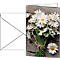 Bouquet of daisies on wood, greeting card and envelope next to it. Natural arrangement.