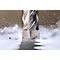 Close-up of a drill bit working on metal. Chips and dust swirling.