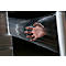 A hand breaking through a transparent film, as if reaching through.