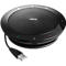 Black Jabra speaker with USB cable. Round design with perforated surface, logo, buttons, and ports.