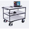 Three-tiered serving cart with laptop, camera, and smartphone. Gray metal frame, white shelves. Wheels for mobility.