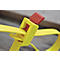 Collier de serrage jaune avec fermoir rouge. Le collier est partiellement fermé et repose sur une surface en bois.