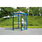 Blue and transparent waiting shelter with man, forest in the background.