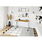 A modern wooden desk with metal legs, placed in a bright, stylish room with decorations.