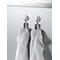 Two white towels hang on hooks. The background is light gray.