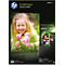 A smiling blonde girl holding pink tulips. On the packaging for HP Everyday photo paper.