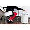 Person inserting paper into a shredder. She is wearing a black blouse, red pants, and sitting at a desk.