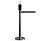 Stainless steel stanchion with hand sanitizer dispenser and barrier tape, against a white background.