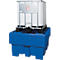 A white IBC container with metal frame sits on a blue spill containment. The container has a hazardous substance symbol.