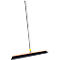 Broom with black bristle head and handle. The handle is black, the holder yellow.