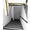 Stairwell with black and yellow hazard markings, gray door and handrail.