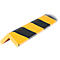 A yellow and black corner protector in L-shape floating in front of a white surface.
