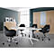 Conference table with black chairs in a modern office. Cabinets and windows in the background.