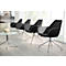 Four black chairs with chrome legs. A small table and a picture are visible in the background.