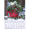 Bol rouge avec décorations de Noël : baies, sapin, fleurs, cônes, posé sur la neige. En bas, calendrier de décembre 2027.