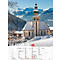 Paysage hivernal avec église, montagnes enneigées et calendrier de décembre.