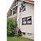 Person on a ladder at a house, cleaning the gutter. A cat is in the window.