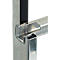 Detailed close-up of a metallic, angular construction connecting two tubes. Sharp edges and precise cutouts.