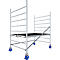 A scaffolding, silver colored, with a black platform, stands on four blue rollers. The construction is suitable for outdoor use.