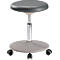 An adjustable office stool with a round, gray seat, chrome-colored column and castors.