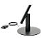 A black table lamp with a round base, the lamp arm, and a charger.