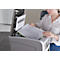 A woman is placing a document into a scanner. The scanner lid is open.