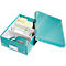 Teal office organizer with office supplies like notes and a hole punch.