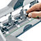 Close-up of a silver hole punch. A hand is turning a black knob.